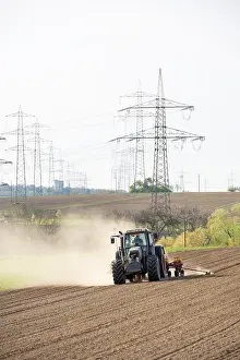 Agricultural Machine Europe Prints: Tractor with seed drill in the field in spring