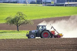 Tractor Seed Drill Prints: Tractor with seed drill in the field in spring
