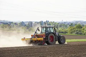 Tractor Seed Drill Prints: Tractor with seed drill in the field in spring