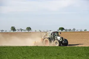 Southern Germany Agricultural Land Prints: Tractor with seed drill in the field in spring