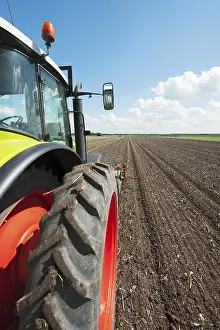 European Farmland Cultivation Prints: Tractor in the vegetable fields with horizon