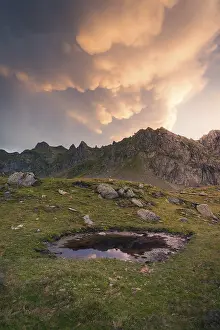 Mountainous Region Landscape Photo Prints: A tranquil mountain scene at sunset showcases dramatic