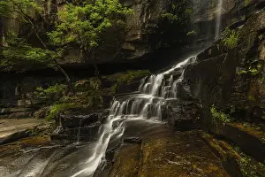 Moss Covered Rocks Prints: A tranquil waterfall flows over rocks and moss