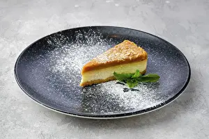 Bakery Treats Prints: Triangular piece of caramel cheese cake on a plate