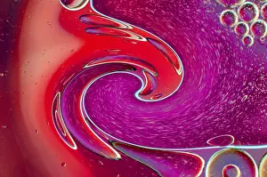 Empty Waterfront Scene Prints: Twirling effect of bubbles on surface of water in red gradient background