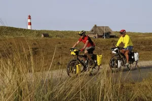 European Lighthouse Photography Prints: Cyclists in front of the Ostellenbogen Lighthouse