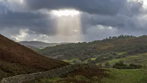 Cloudy Sky With Sun Rays Prints: Typical landscape with stone wall