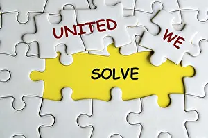 Teamwork Concept Prints: United We Solve text on missing jigsaw puzzle representing teamwork and unity