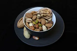 Plain Colored Background Studio Shots Prints: Various nuts on plates, Germany