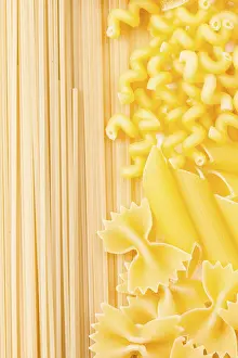 Appetizing Meal Ideas Prints: Various pasta types as a background on the table