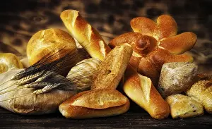 Warm Light Photography Prints: Various types of bread in a rustic setting with warm light