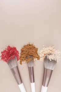 Professional Makeup Tools Prints: Top vertical view of three makeup brushes with samples of loose makeup textures