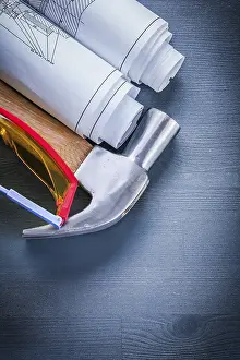 Blueprint Design Concept Prints: Vertical view rolled up blueprints hammer goggles