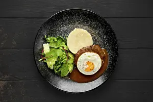 Gastronomy Plate Prints: Top view of beef cutlet with fried egg