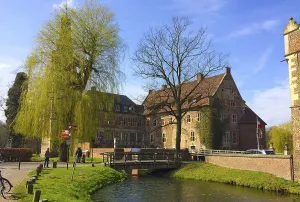 Münsterland Tourist Attraction Prints: View of the excursion destination Westphalian moated castle Raesfeld in beginning spring with budding trees