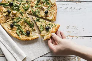 Pizza Studio Shot Prints: Top view hand taking slice pizza