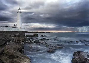 Towering Lighthouse Structure Prints: A view of a lighthouse a storm