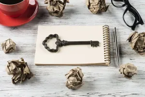 Creative Workspace Inspiration Prints: Top view of modern creative workplace with key on notepad