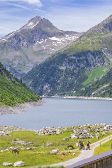 Blue Sky Mountain Lake View Prints: View of a mountain lake with cyclists on a path