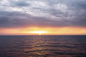 Setting Sun Over Sea Prints: View across the open sea to the setting sun