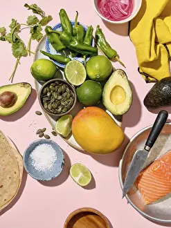 Avocado Nutrition Facts Prints: Top view of a vibrant array of taco ingredients spread on a pink backdrop