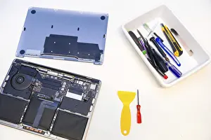 Caucasian Male Worker Prints: Top view of a white workshop table with tools and digital tablet to repair