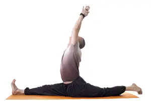 Fitness Wellbeing Prints: Side view of yoga trainer posing on split