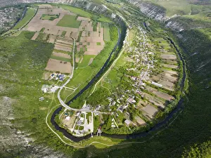 Prints of Village in a hilly landscape with fields and a meandering river, aerial view, Butuceni, Raut, Old Orhei, Orheiul Vechi, archaeological site, protected landscape area, Orhei district Moldova Prints: Print of Orheiul Vechi Village in Moldova