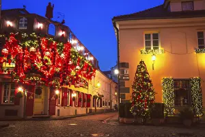 Prints of Vilnius, Lithuania - 30th november, 2024: Wonderful creative Christmas decorations on famous stikliai street in Vilnius old town. Holidays decorations. Bright lights decor by cafes and restaurants Lithuania Prints: Vilnius Old Town Christmas Decorations Print