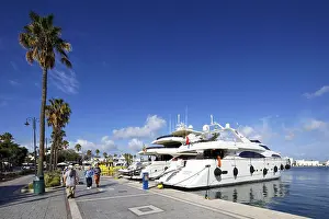 Prints of Visitors stroll along harbor promenade, luxury motor yacht, palm trees, Mandraki harbor, seaport, old town, Kos town, Kos island, Dodecanese islands, Greece, eastern Adriatic, Mediterranean Kosovo Prints: Mandraki Harbor Print, Kos Island, Greece