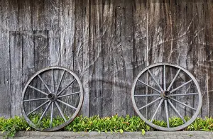 North Rhine Westphalia Europe Prints: Two wagon wheels lean against a barn wall
