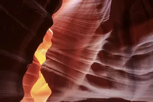 Upper Antelope Canyon USA Prints: Warm rays of sunlight illuminate the undulating structures inside a rock cave
