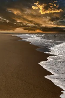 US American Coastal Landscape Prints: Waves on empty beach, dramatic cloudy sky at sunset