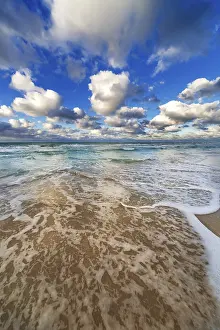 Deserted Sandy Beach Prints: Waves lapping on the sandy beach