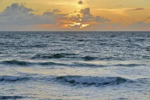 Deserted Beach At Dusk Prints: Waves running out on the beach at sunset