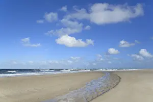 Deserted Sandy Beach Scene Prints: Waves running out at the sandy beach