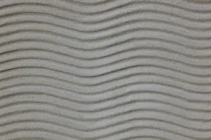 Undulating Wave Pattern Prints: Wavy plaster structure on a building