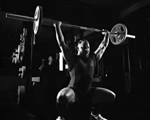 Young Weightlifter Prints: Weightlifter does an exercise with a barbell
