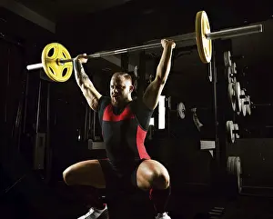 Young Weightlifter Prints: Weightlifter does an exercise with a barbell