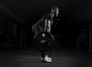 Fitness Studio Workout Prints: The weightlifter performs an exercise called deadlift