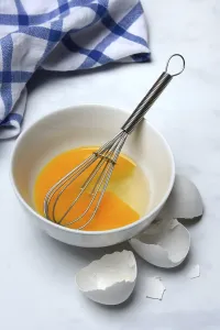 Plain Colored Background Eggs Prints: Whipped egg in shell with whisk, egg shells