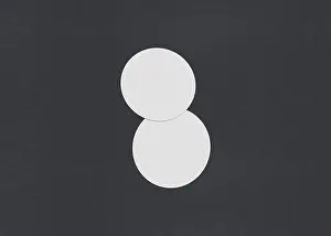 Business Card Template Design Prints: Two white circular sheets overlapping on a dark background
