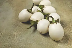 Natural Colors Prints: Several white eggplants are placed on a textured surface