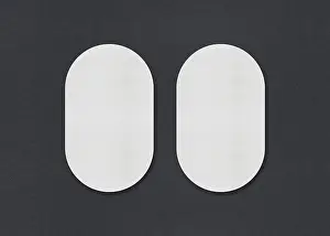 Business Card Design Ideas Prints: Two white oval sheets side by side on a gray background