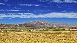Cordillera De Los Andes Mountainscape Prints: Wide fields in front of a mountain range under a cloudy sky