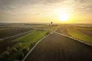 Atmospheric Evening Light Germany Prints: Wide fields at sunset with a road network