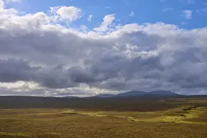European Mountainous Landscape Prints: Wide plain with cloudy sky and distant mountains in the background