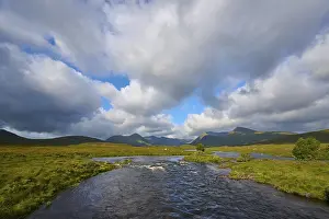 UK Countryside Photography Prints: Wide river landscape under dramatic clouds and mountains in the background