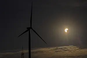 Cloudy Sky With Wind Turbines Prints: Wind power plant, clouds, partial solar eclipse