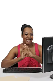 Female Manager At Desk Prints: Woman executive or manager using a desktop computer
